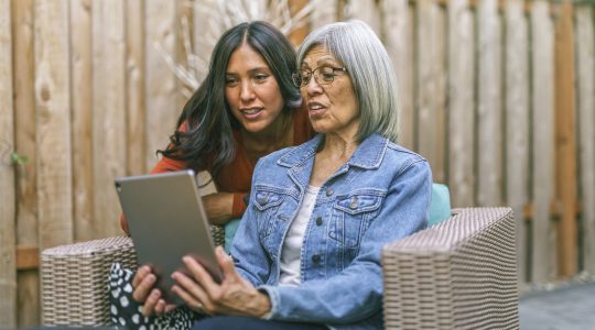 Senior woman learning to use tablet computer with the help of her adult daughter | Sunny Vista Senior Living Colorado Springs